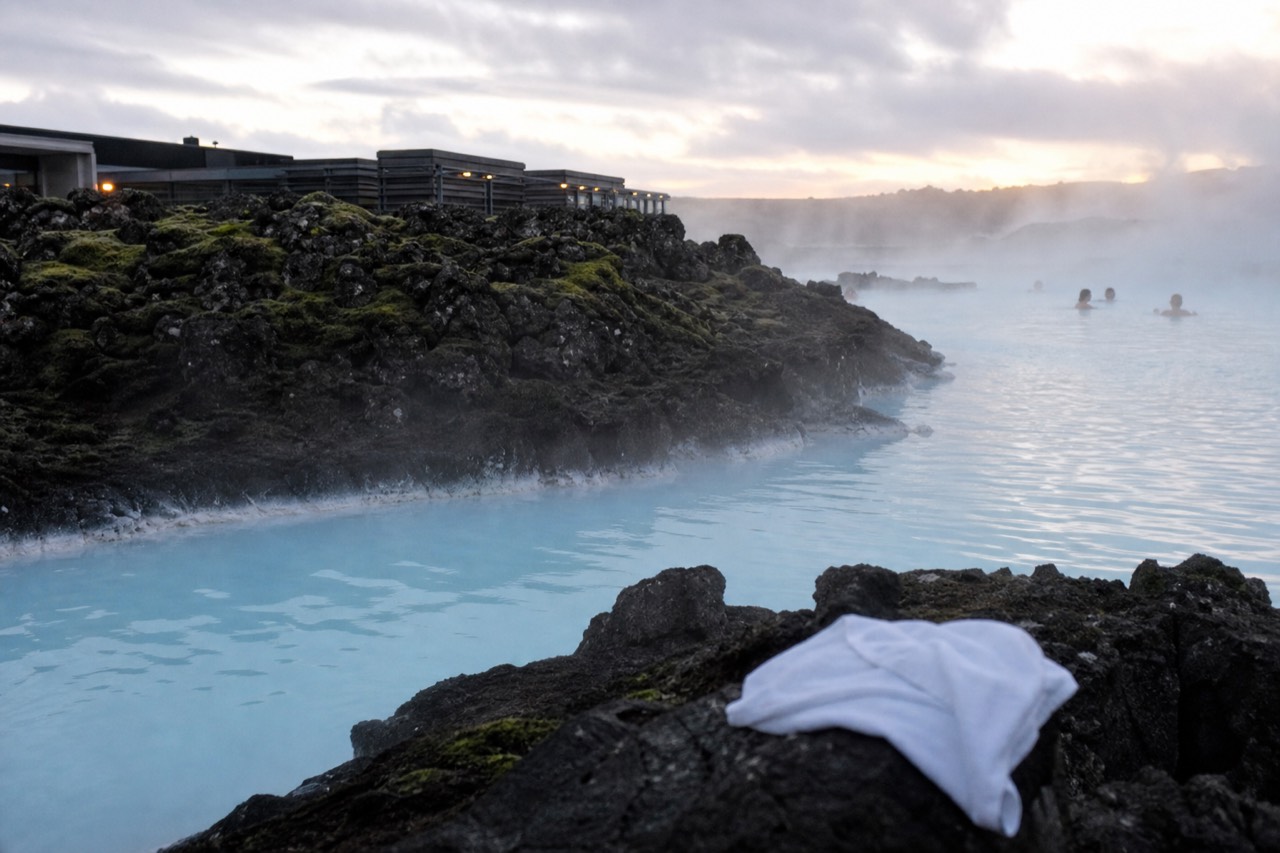 Steam rising from a geothermal lagoon beside a dark lava field on the Reykjanes Peninsula