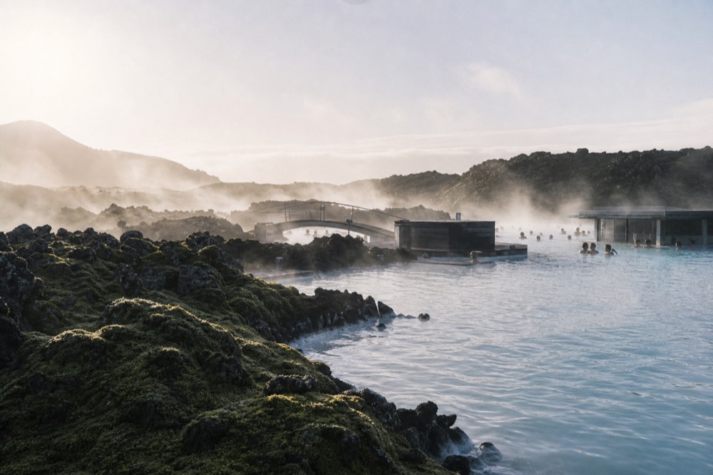 Soft morning light over a geothermal lagoon and distant hills