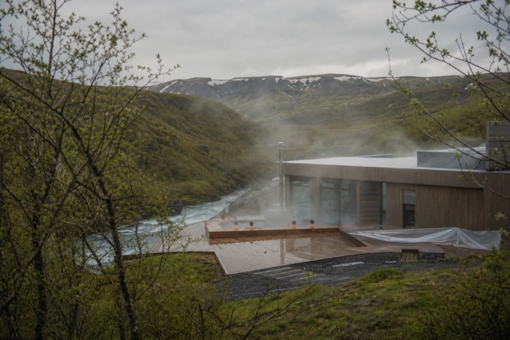 A new timber bathing complex beside a steaming river valley