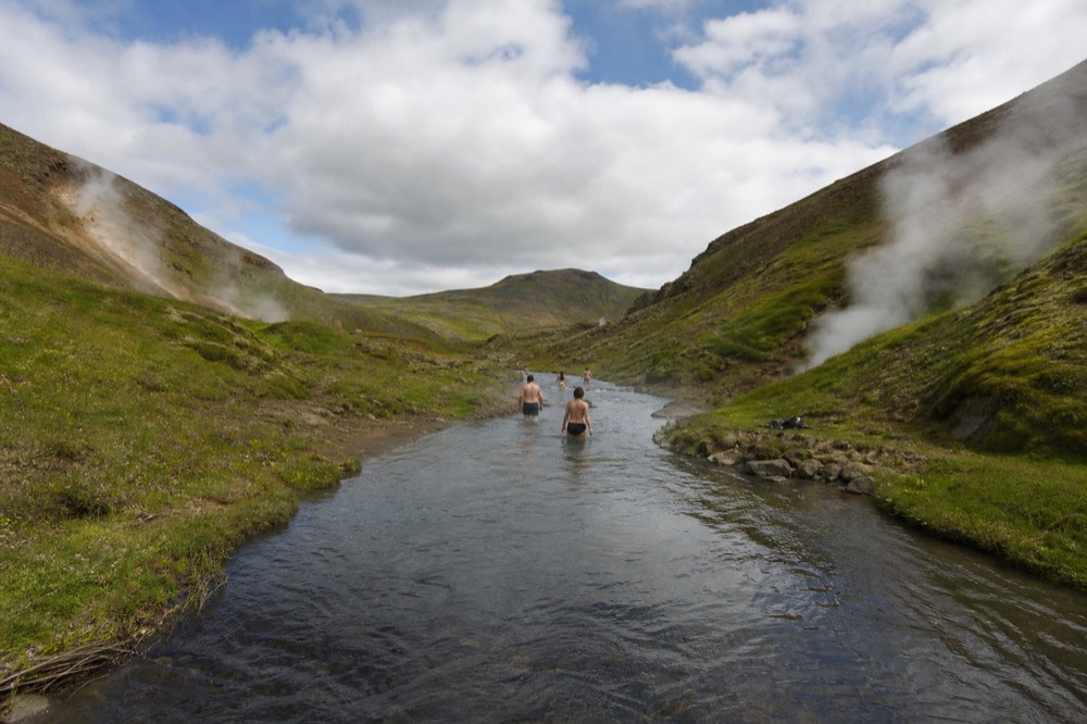 A steaming hot stream running through a green valley in south Iceland