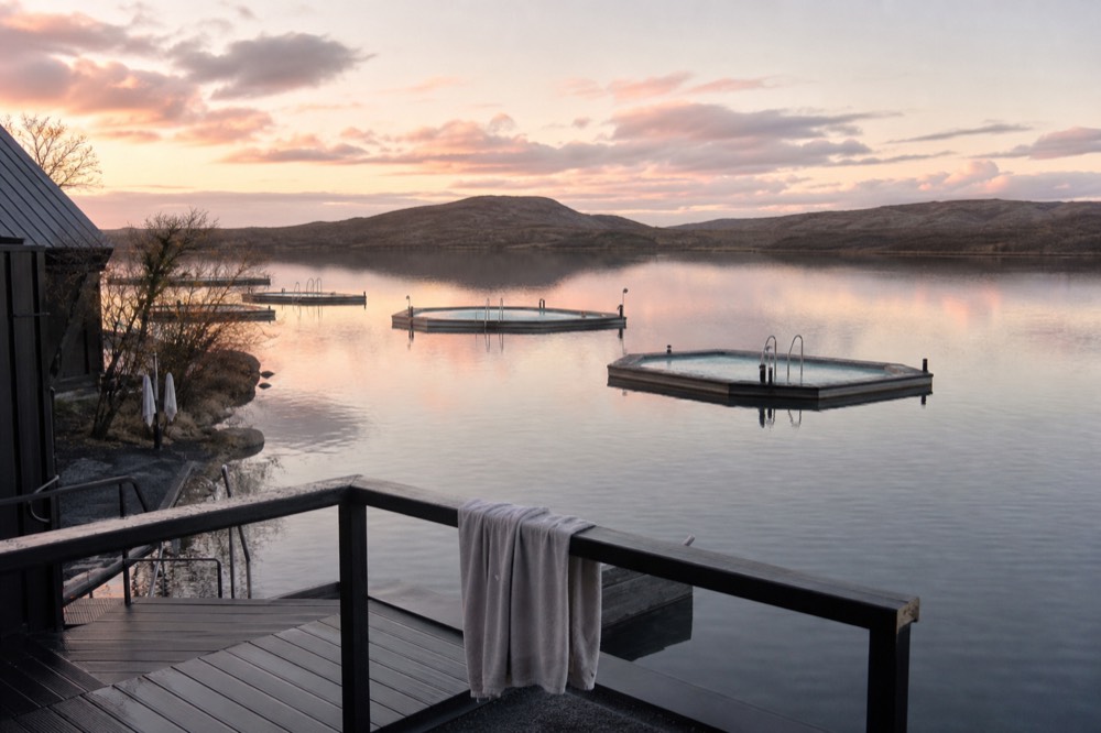 Floating geothermal pools on a calm lake at twilight in East Iceland