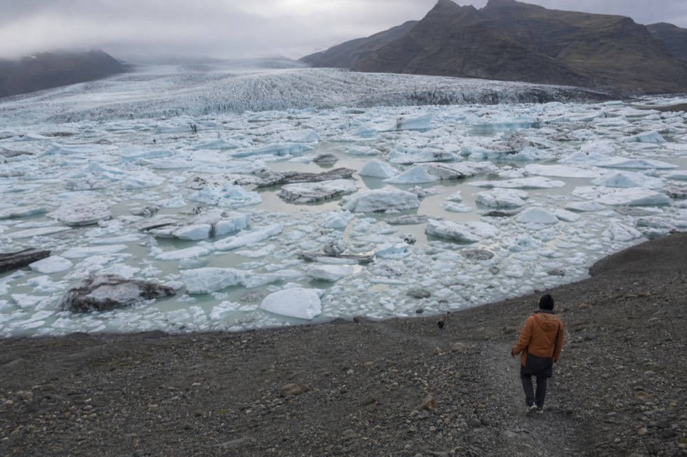 Icebergs of different sizes crowded together near the calving front of a glacier