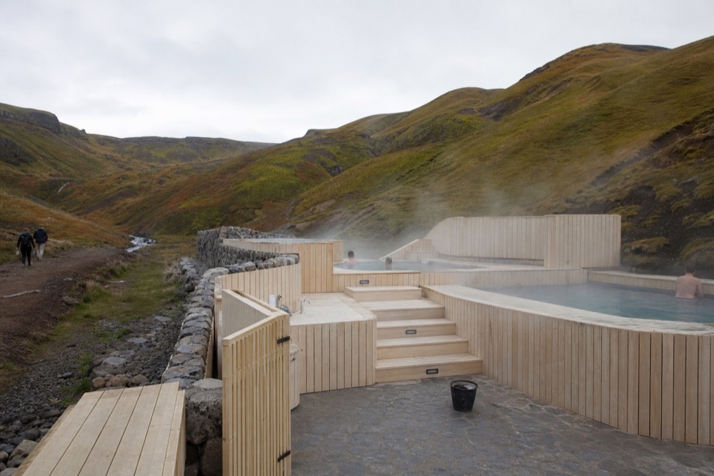 Newly built geothermal bathhouse at the entrance to a steamy valley