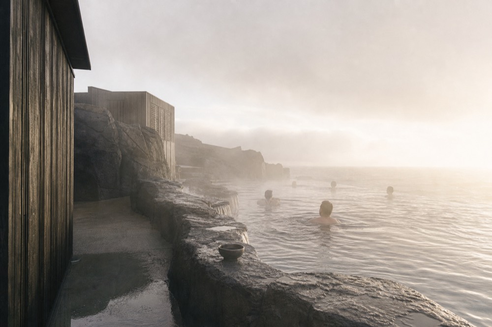 Infinity edge of a steaming lagoon meeting the open ocean